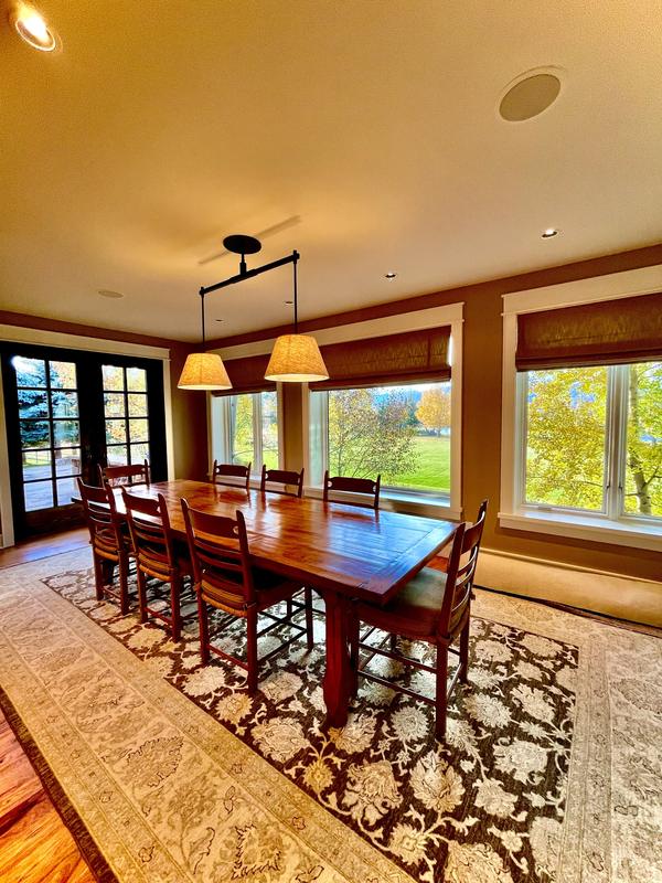 Dining room with a timber table and patterned rug