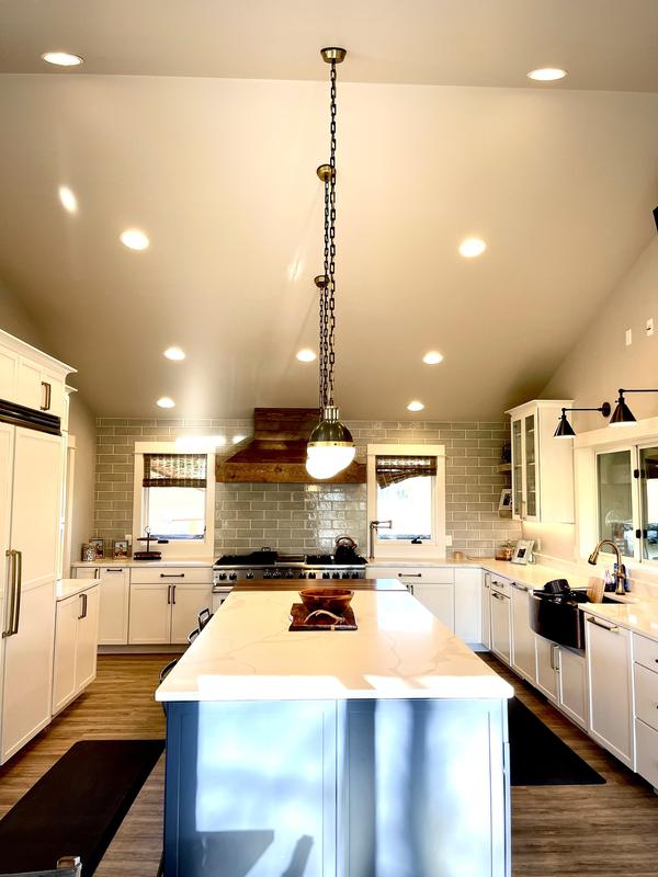 White kitchen with range hood and island