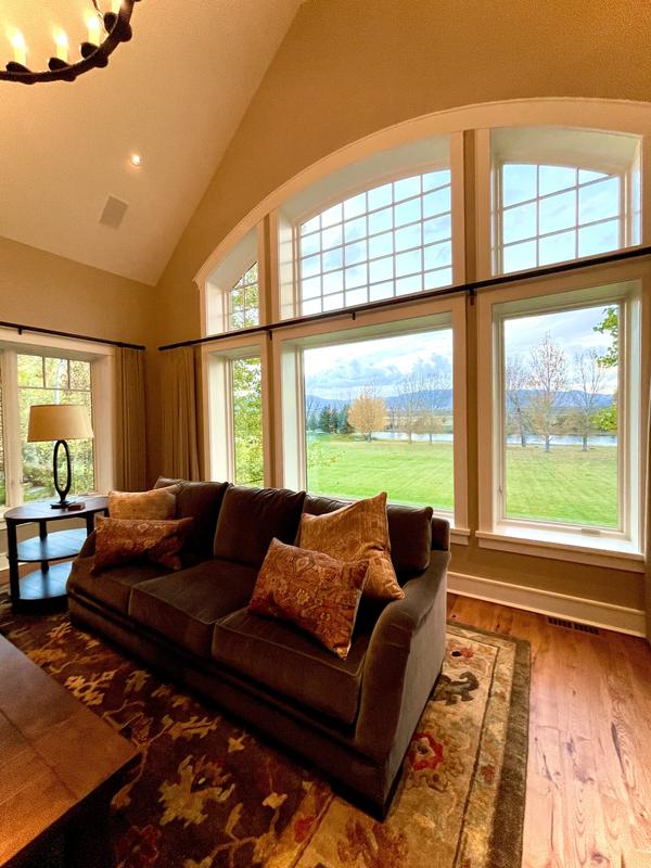 Sunroom with arched windows over the lawn